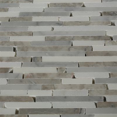 White and gray marble tile wall with staggered rectangular pieces.