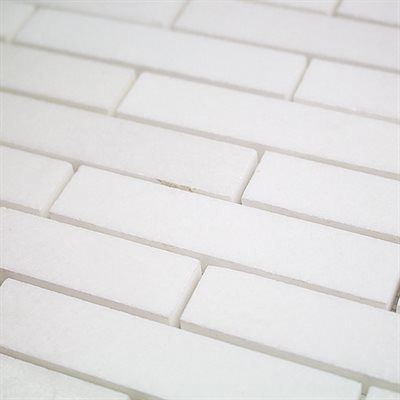 White rectangular tiles arranged in a staggered pattern, covering a surface.