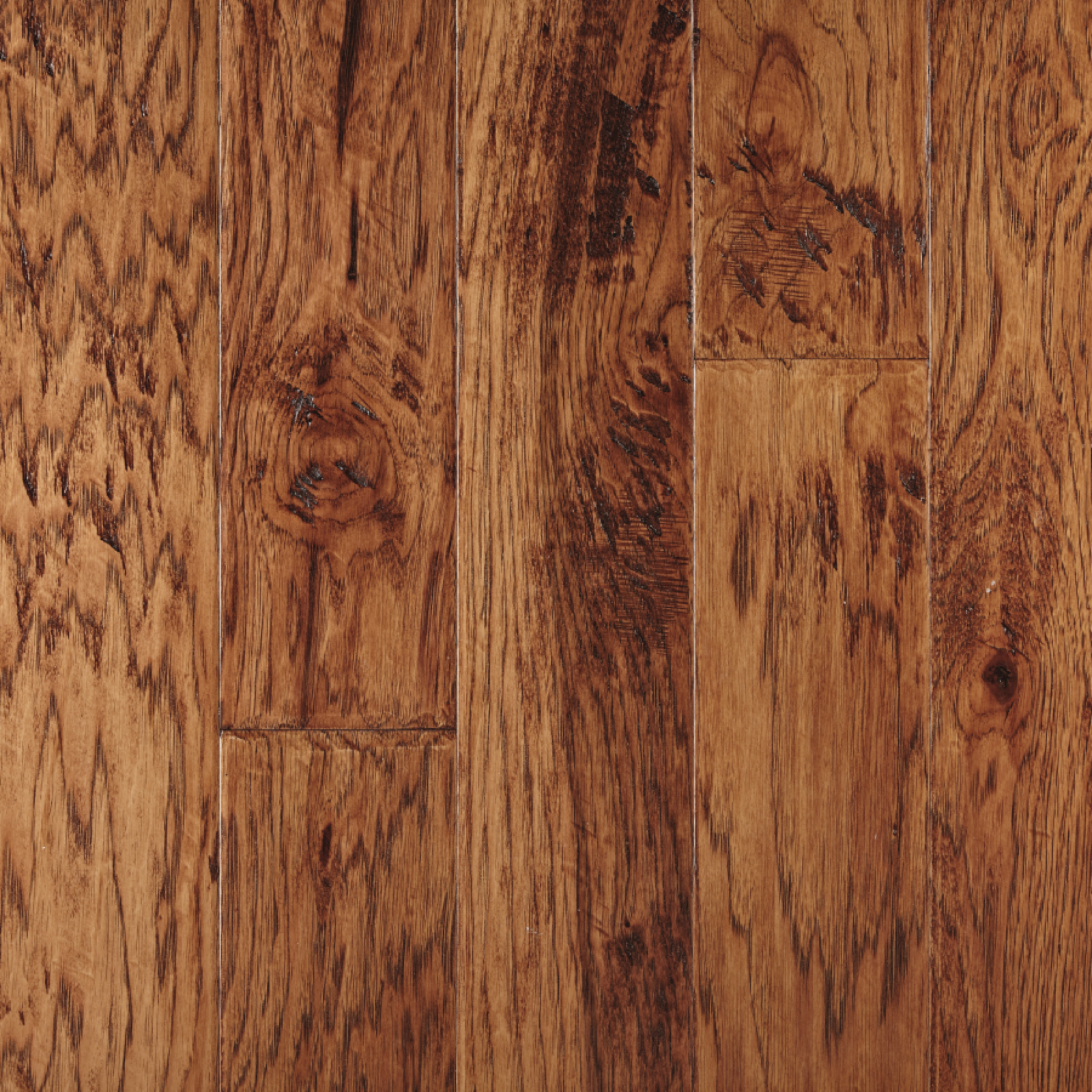 Close-up of hardwood flooring; warm brown with prominent wood grain and knots.