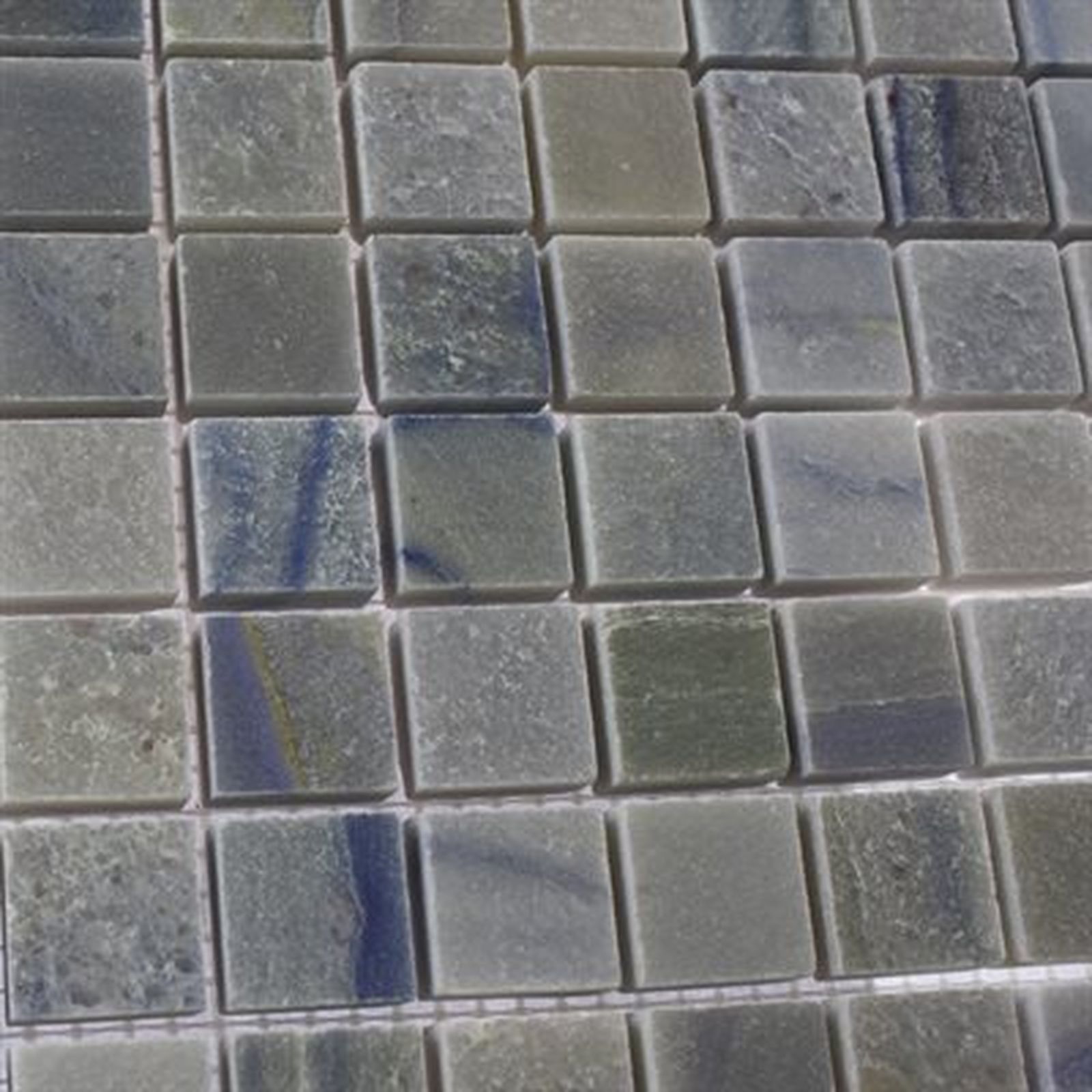 Close-up of square, mosaic tiles in shades of blue and green.