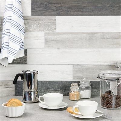 Coffee setup with cups, espresso maker, and wood-look backsplash in a kitchen setting.
