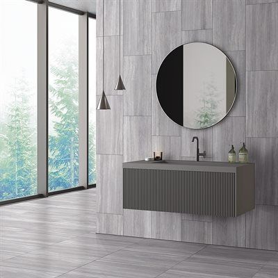 Modern bathroom with gray wall panels, a floating vanity, and a round mirror.