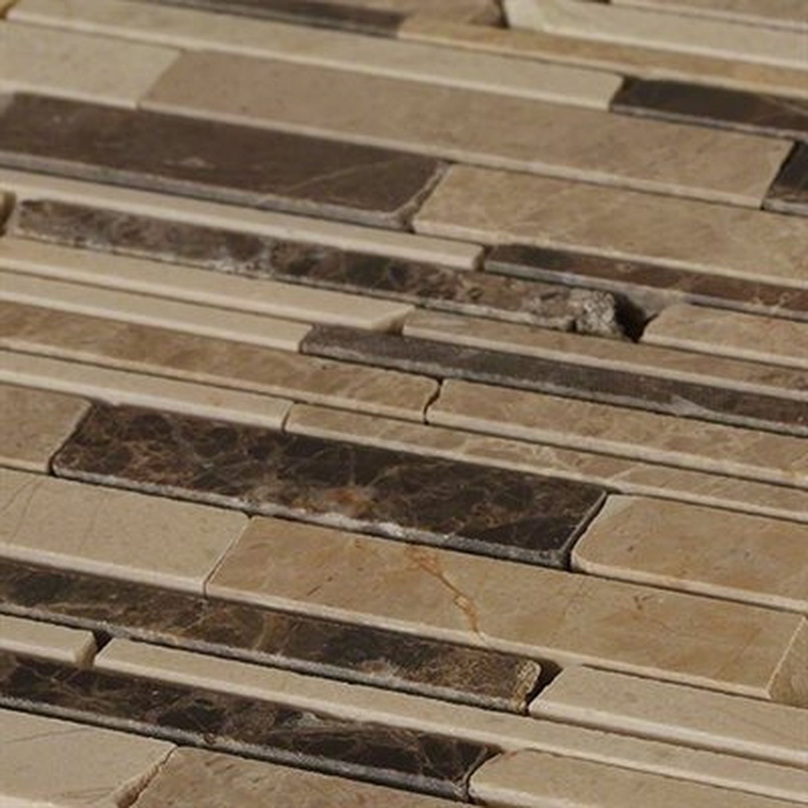 Close-up of a wall with alternating beige and dark brown, rectangular stone tiles.