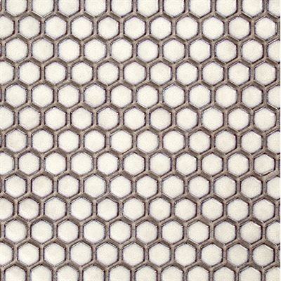 Close-up of a honeycomb-patterned tile, featuring beige hexagonal tiles with grey grout.