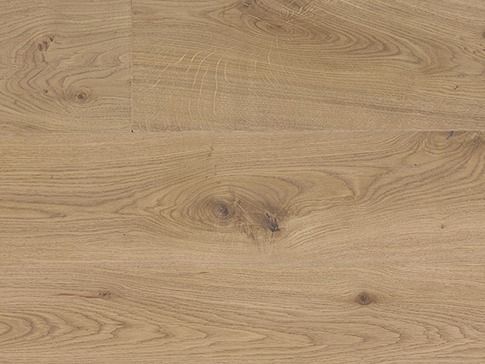 Close-up of light brown wood flooring with visible grain and knots.