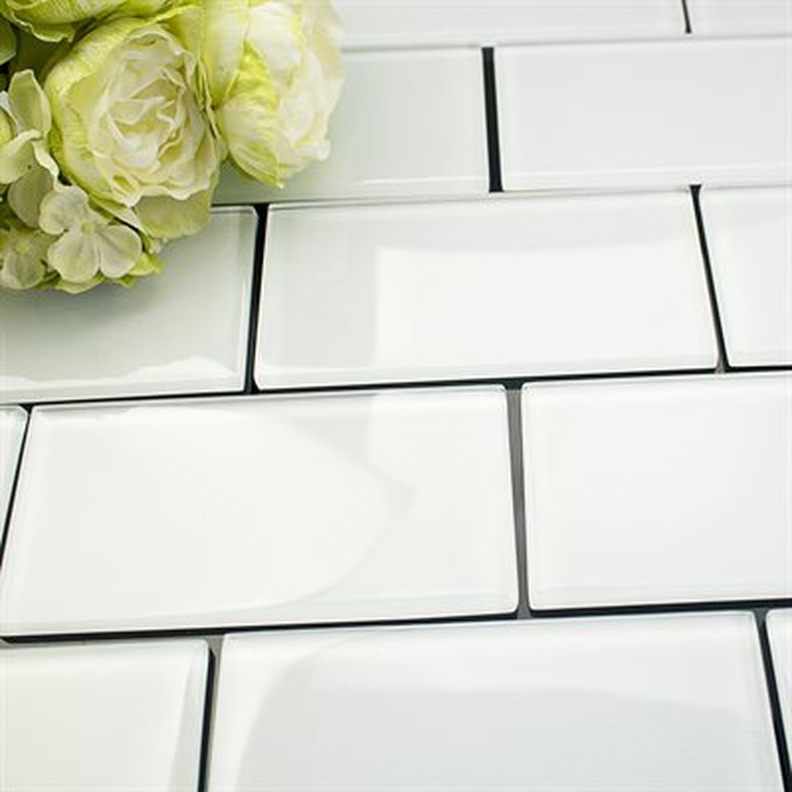 White rectangular tiles with a bouquet of white flowers on the left.