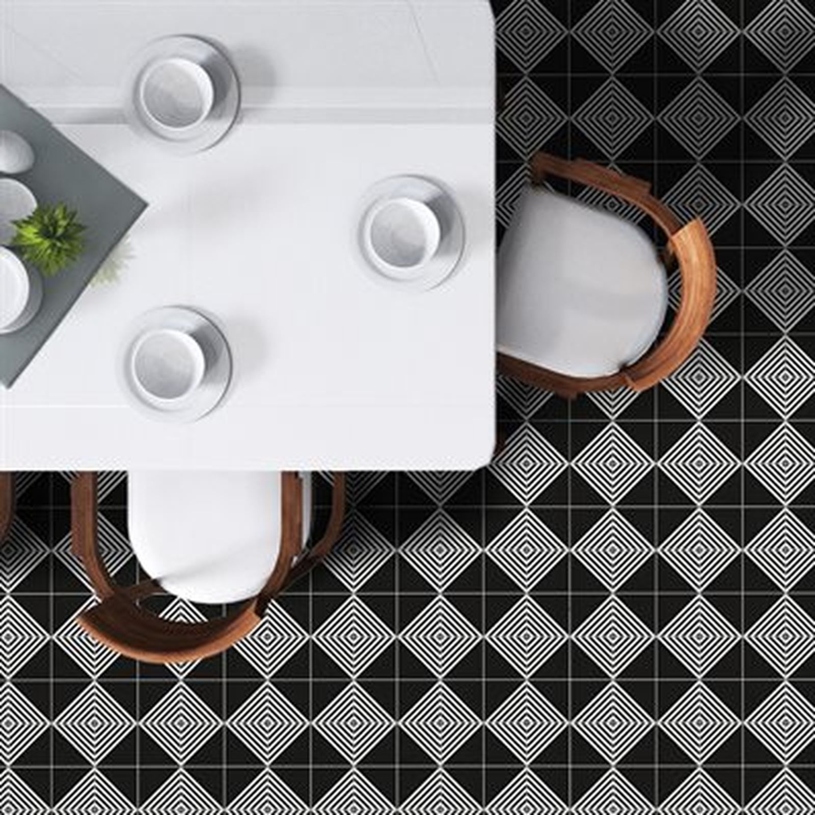 White table with place settings, chairs, and geometric black and white tile flooring.