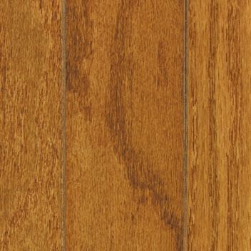 Close-up of three parallel planks of golden-brown hardwood flooring, showing wood grain.