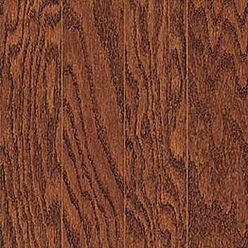 Close-up of hardwood flooring; warm brown with prominent wood grain.