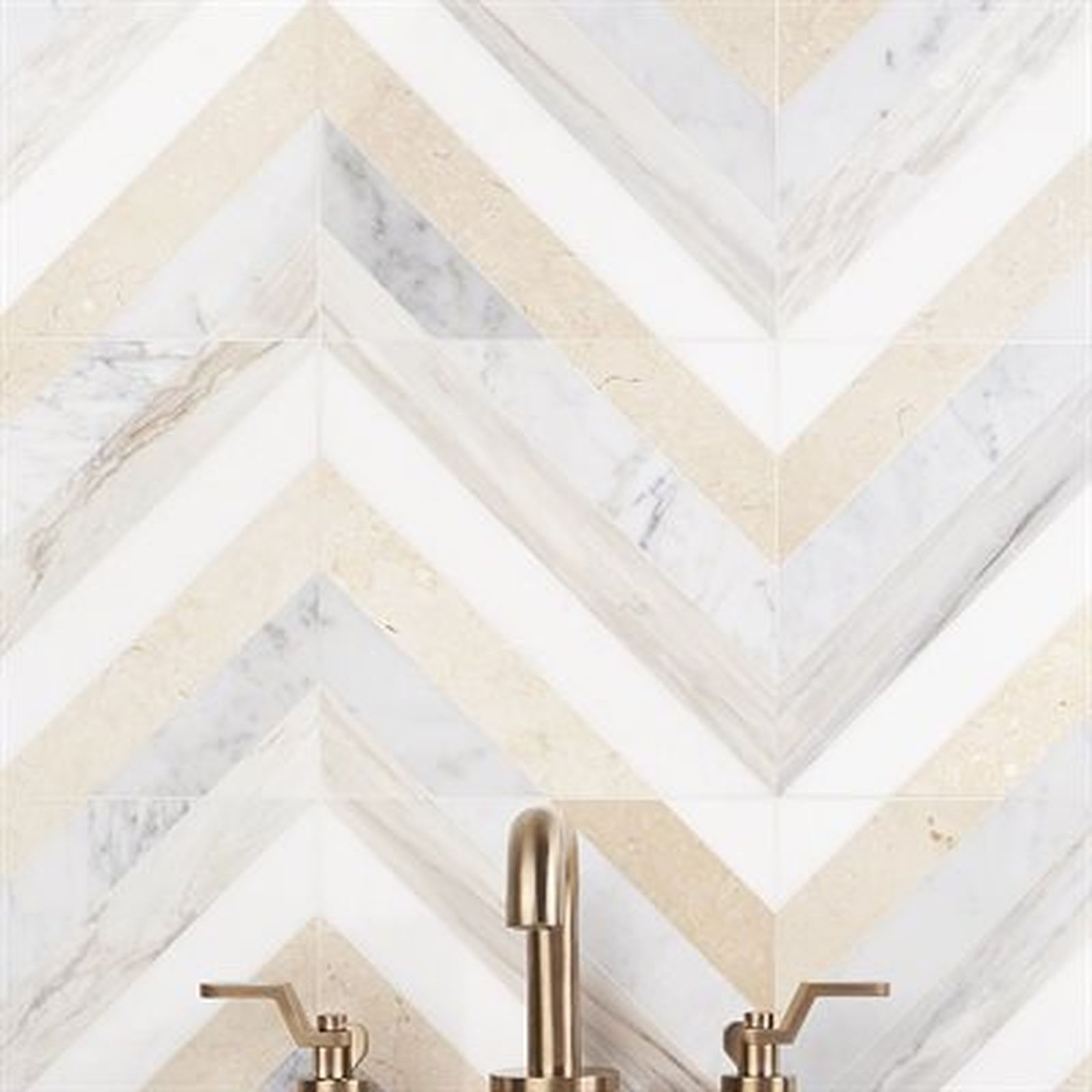 Herringbone tile backsplash with white, beige, and gray marble. Gold faucet below.