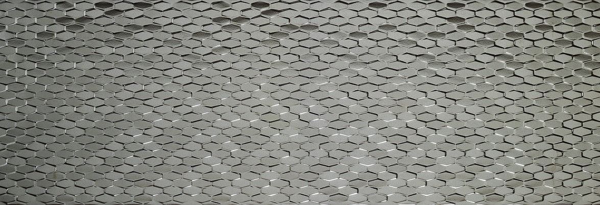 Close-up of a textured, speckled gray surface, possibly metal or fabric.