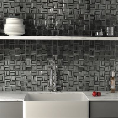 Kitchen backsplash with textured silver tiles, white sink, and shelf with dishes, glasses, and bottles.