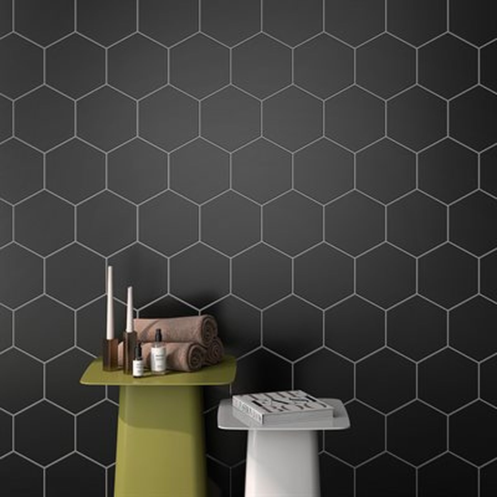 Black hexagonal tile wall with olive and white stools, towels, and toiletries.