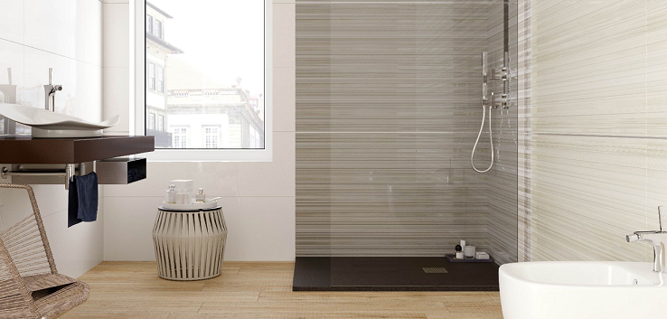 Modern bathroom with a walk-in shower, wooden floor, and a window.