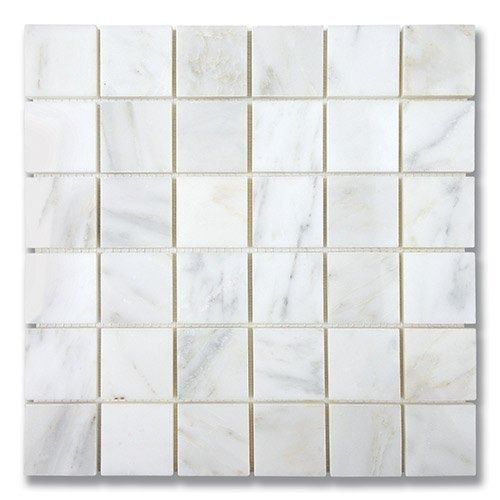 White marble tile mosaic with square tiles arranged in a grid pattern.