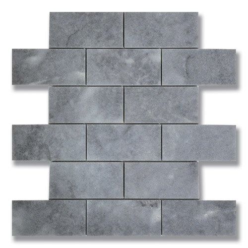 Gray brick-patterned tile mosaic. Rectangular tiles in varying shades of gray arranged in a staggered pattern.