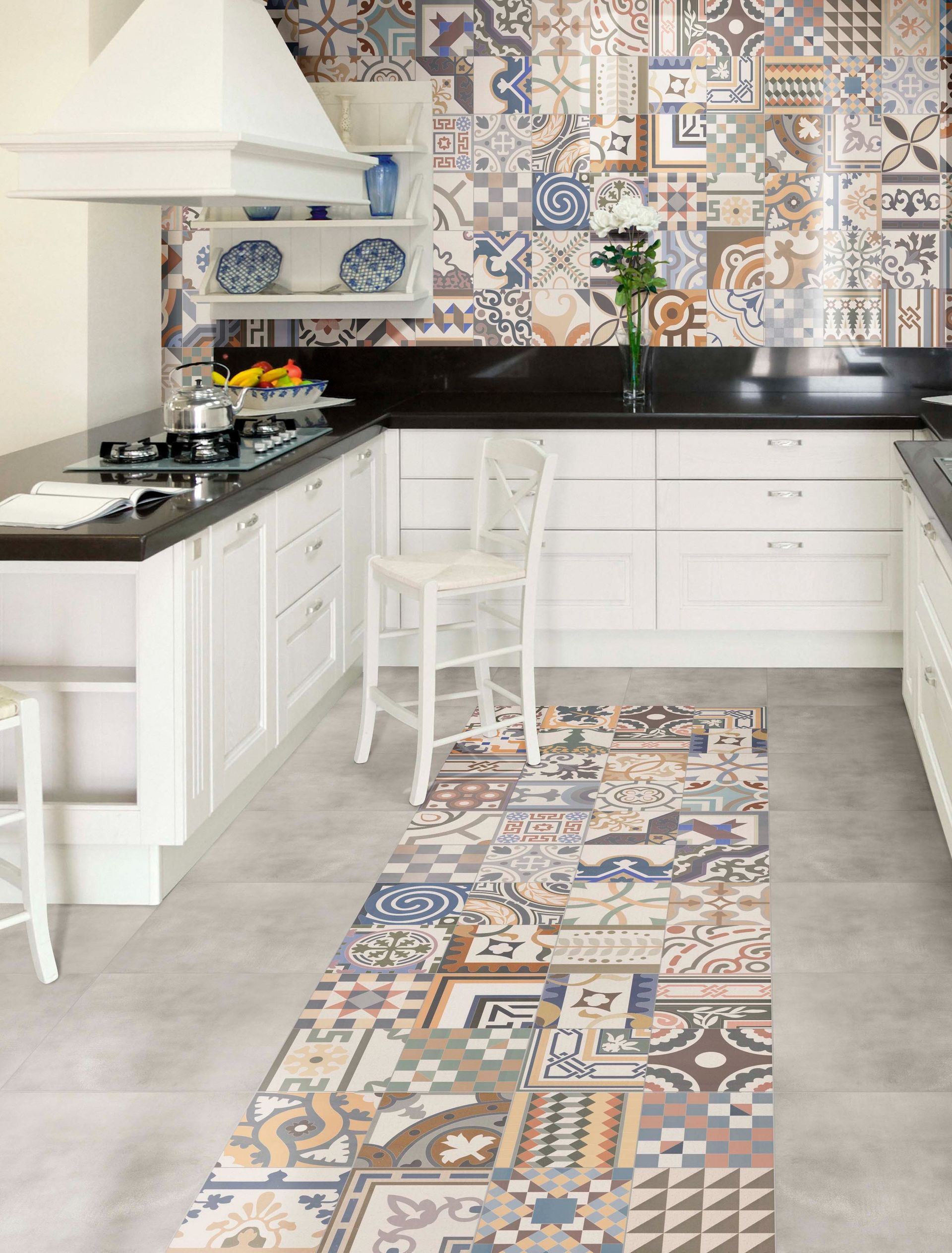 Kitchen with patterned tile backsplash and runner rug, white cabinets, and black countertops.