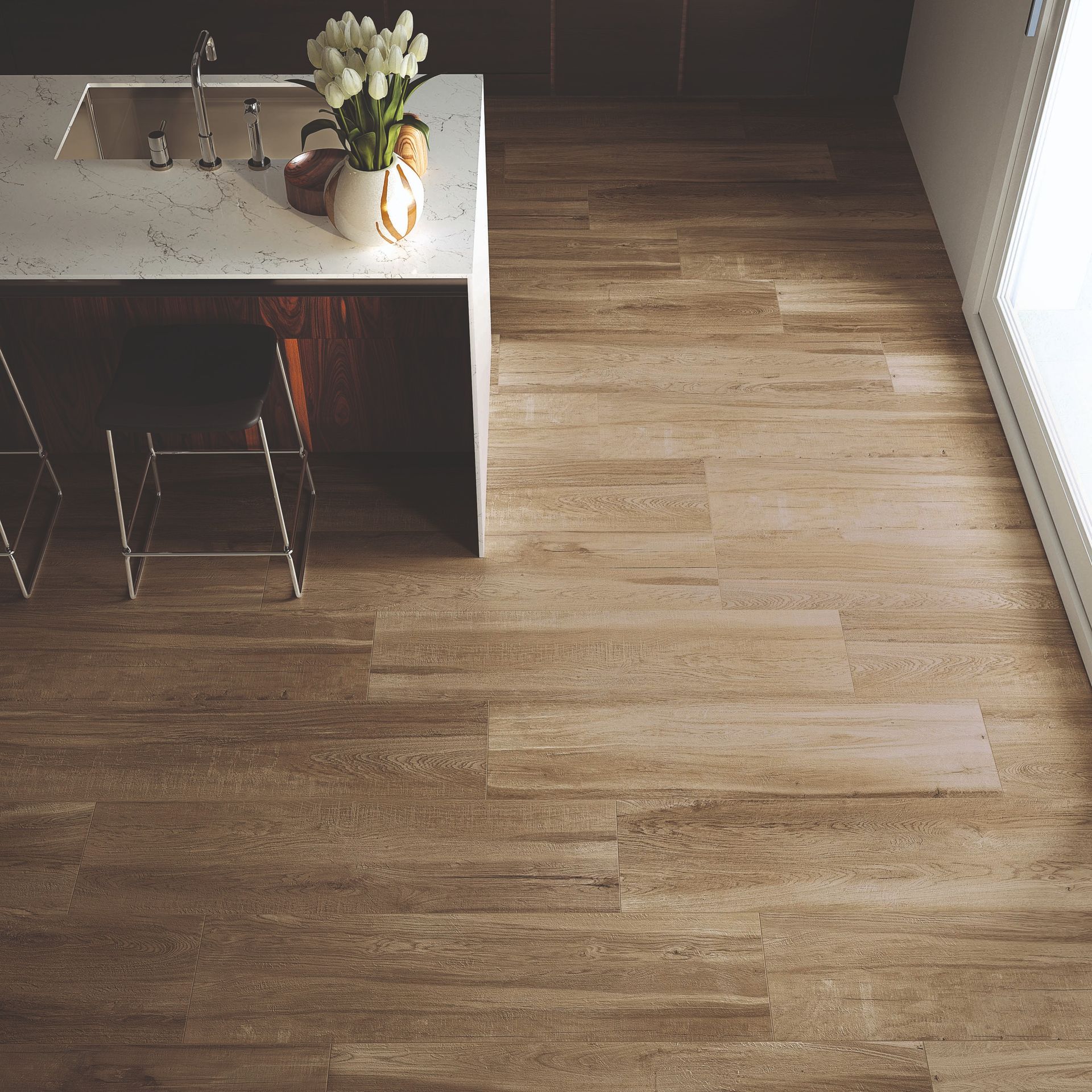 Kitchen with light brown wood-look tile flooring. Island with a white countertop and stools, flowers in a vase.