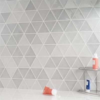 Gray and white triangle tile backsplash in a bathroom.