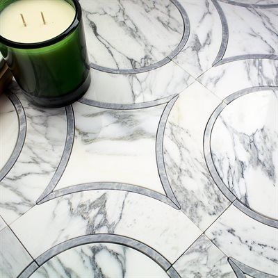 Marble tile floor with grey circular inlays; green candle.