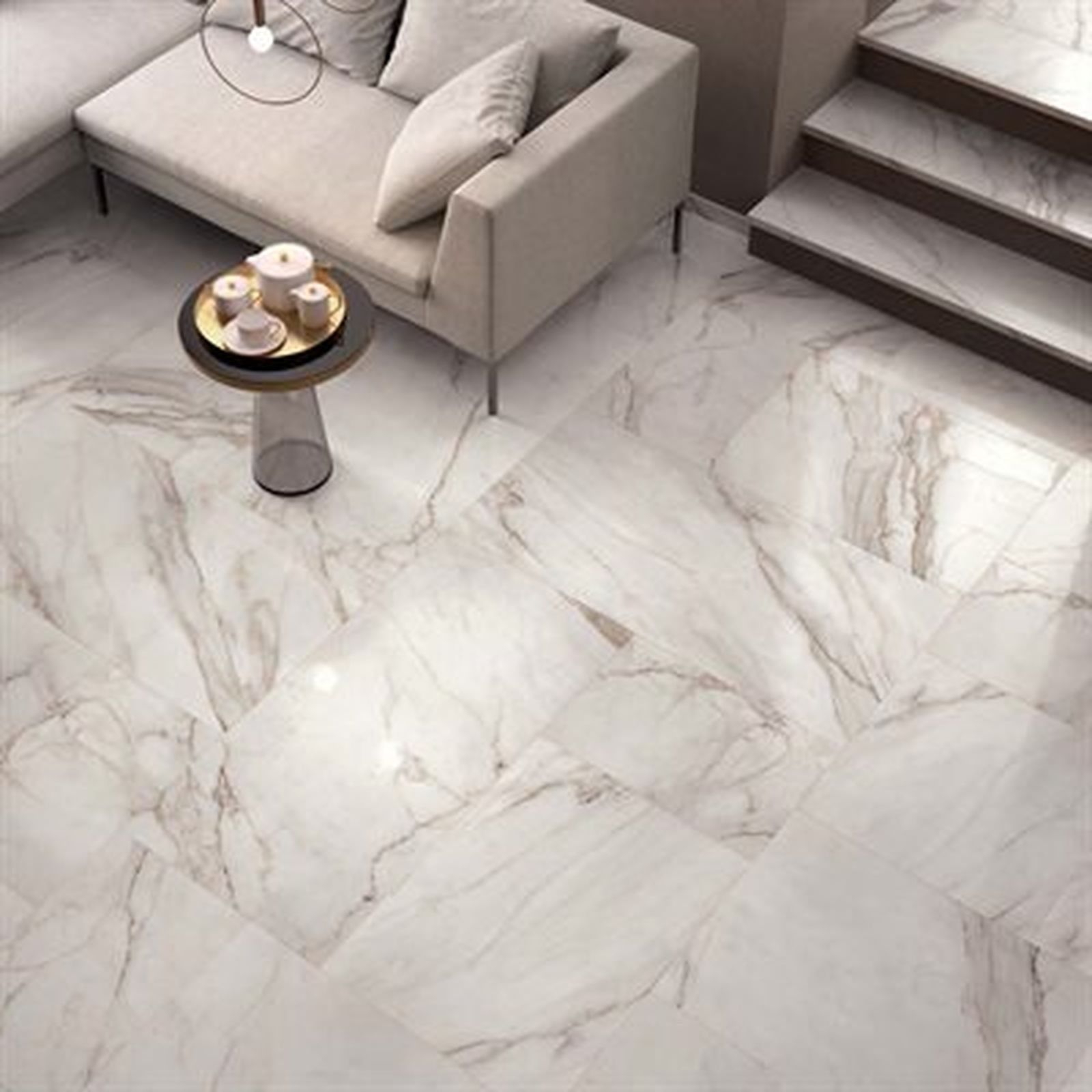 Marble-tiled floor in a modern living room with a beige sofa, small table, and a staircase.