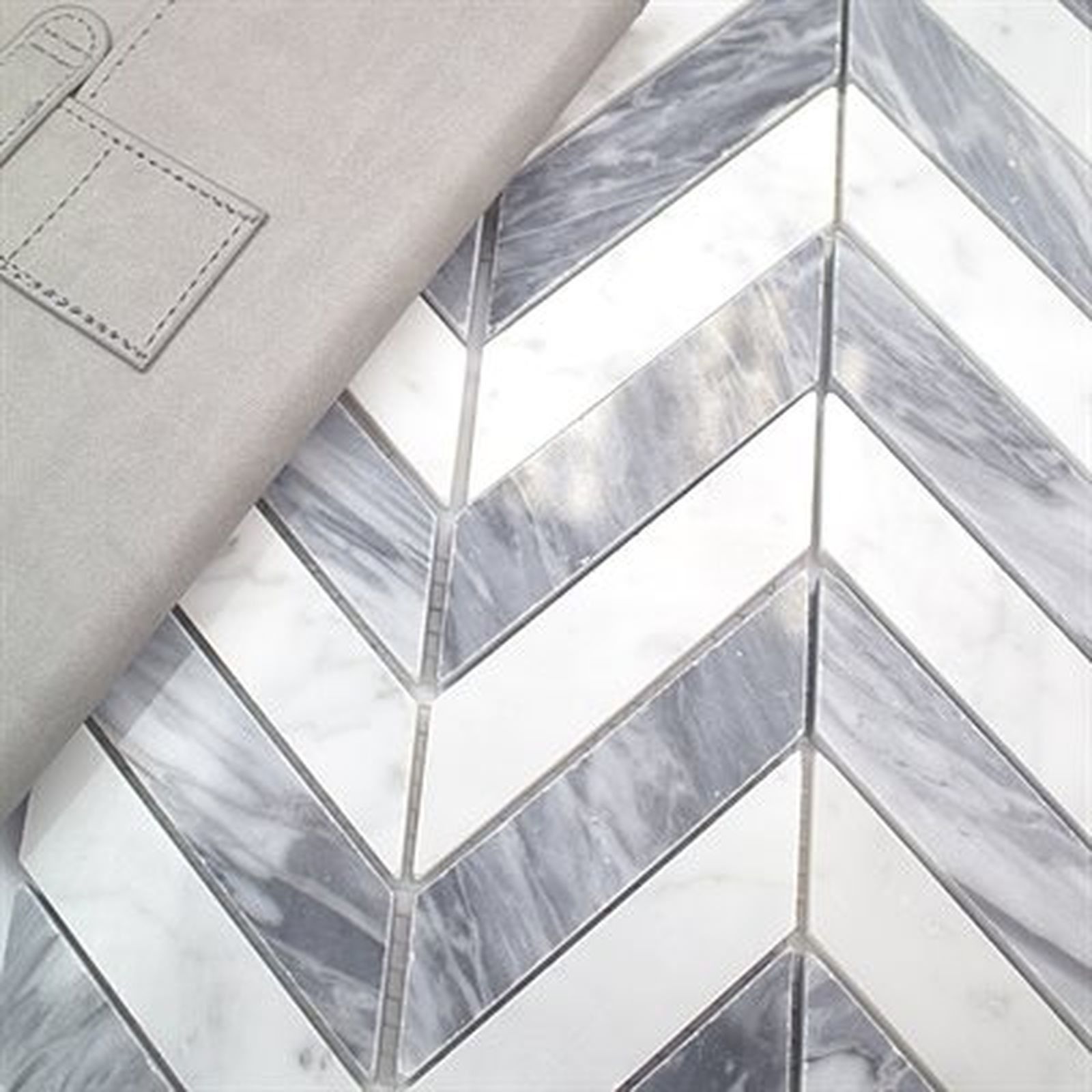 Gray leather planner on marble tile with white and gray chevron pattern.