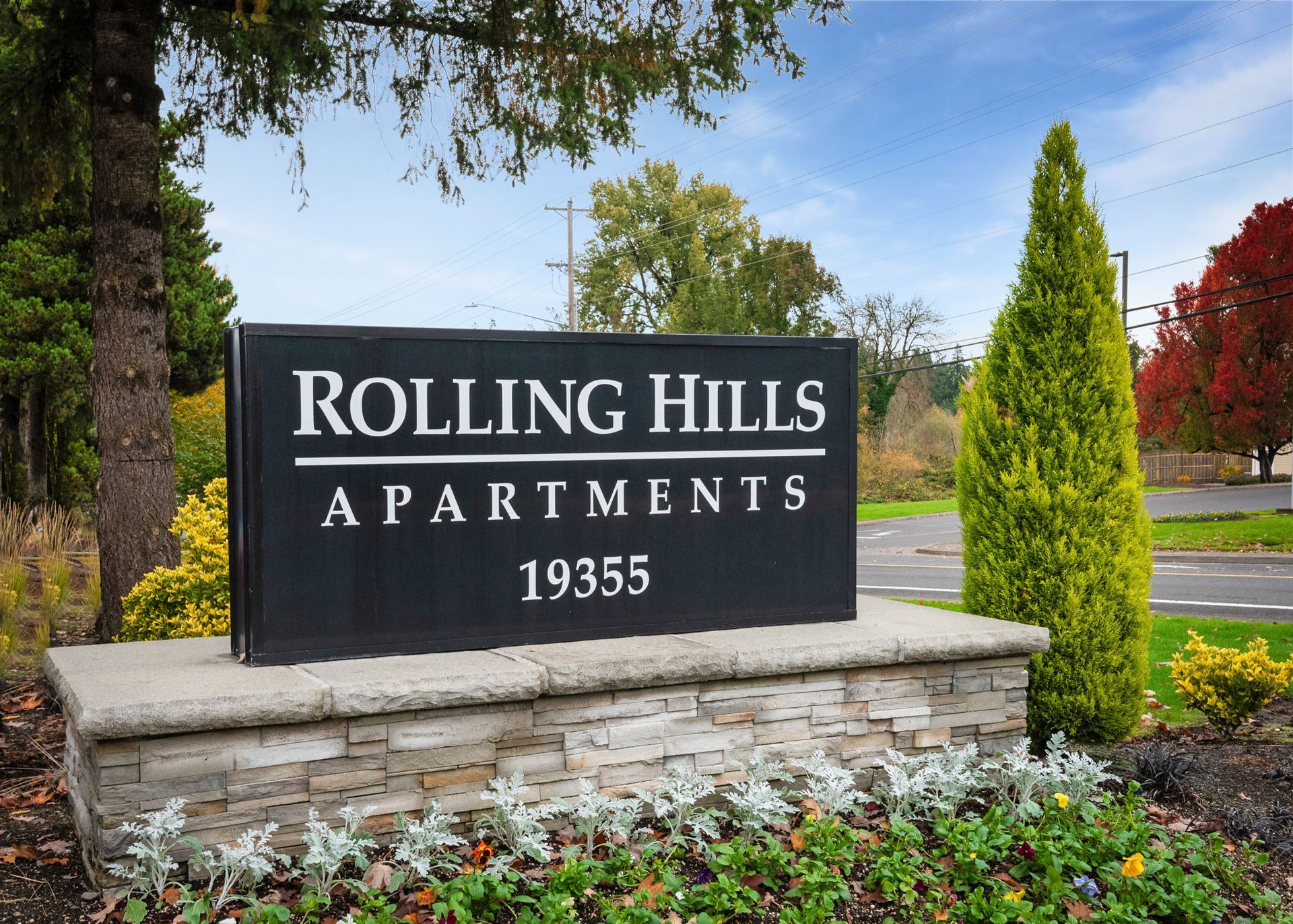 Rolling Hills Apartments entrance sign with landscaped surroundings.