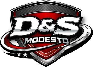 Logo for D&S Auto Repair in Modesto, featuring a car and a truck above the business name inside a red and black shield.