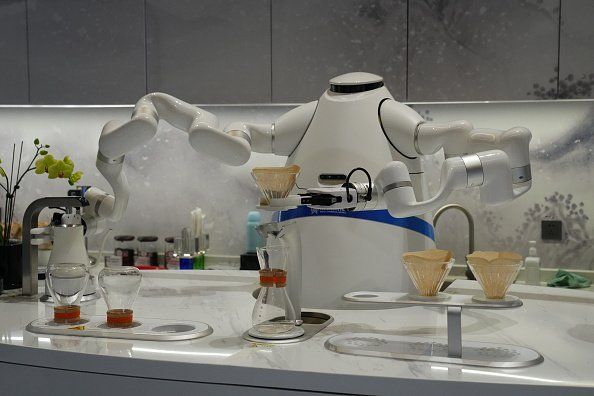 ZHANGJIAKOU, CHINA - FEBRUARY 05: A robot coffee maker prepares a beverage at Zhangjiakou train station on February 5, 2022 in Zhangjiakou, China. (Photo by Carl Court/Getty Images)