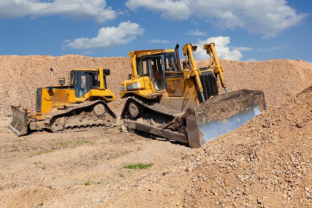 Two Bulldozers Are Sitting on Top of A Pile of Dirt — Top End Diesel In Wishart, NT
