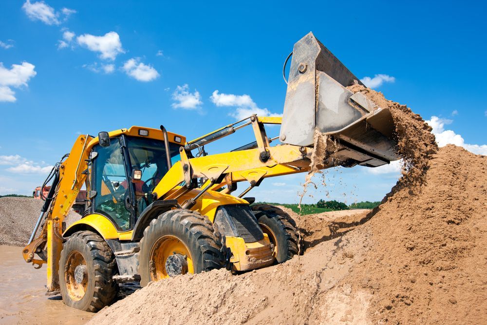 A Yellow Bulldozer Is Loading Dirt Into a Pile — Top End Diesel In Wishart, NT
