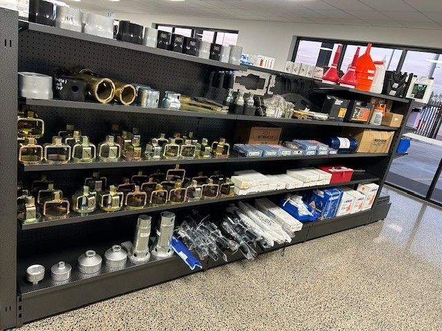 A Person Is Holding a Clutch Cover in Their Hands in Front of A Tractor — Top End Diesel In Wishart, NT
