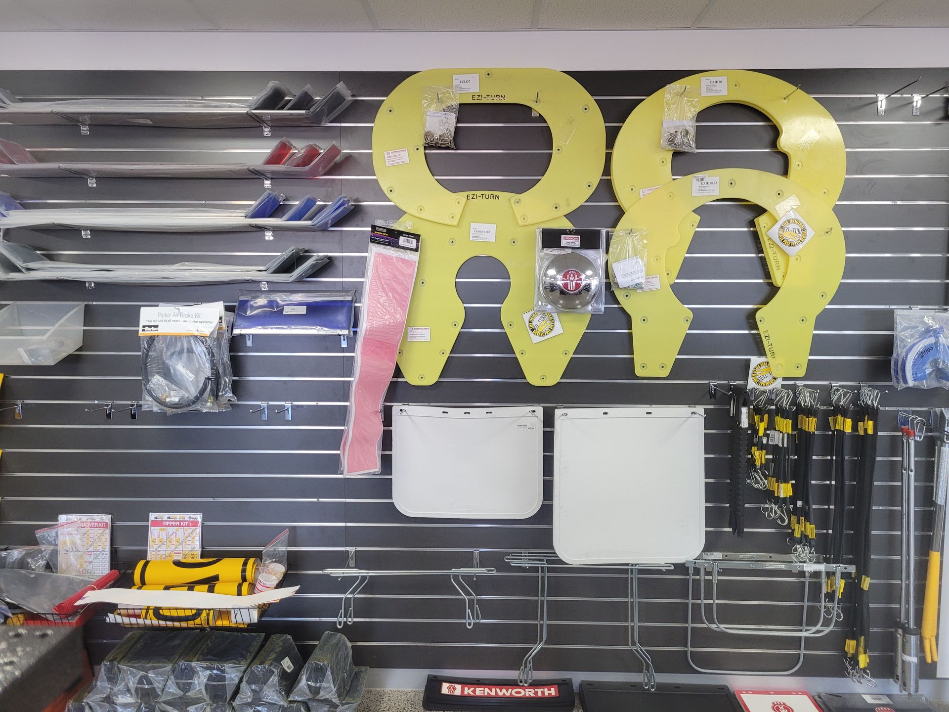 A display of yellow and white safety equipment on a store wall. Includes face shields, and other hardware. — Top End Diesel In Wishart, NT
