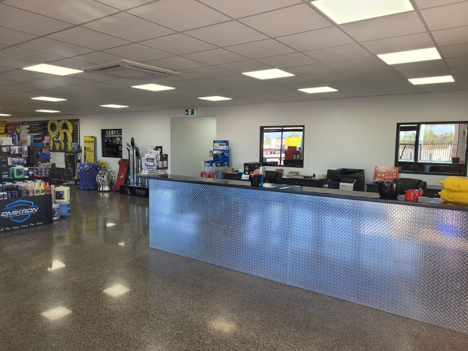 Inside of an auto parts store with a diamond-plate counter, shelves of products, and a polished concrete floor. — Top End Diesel In Wishart, NT