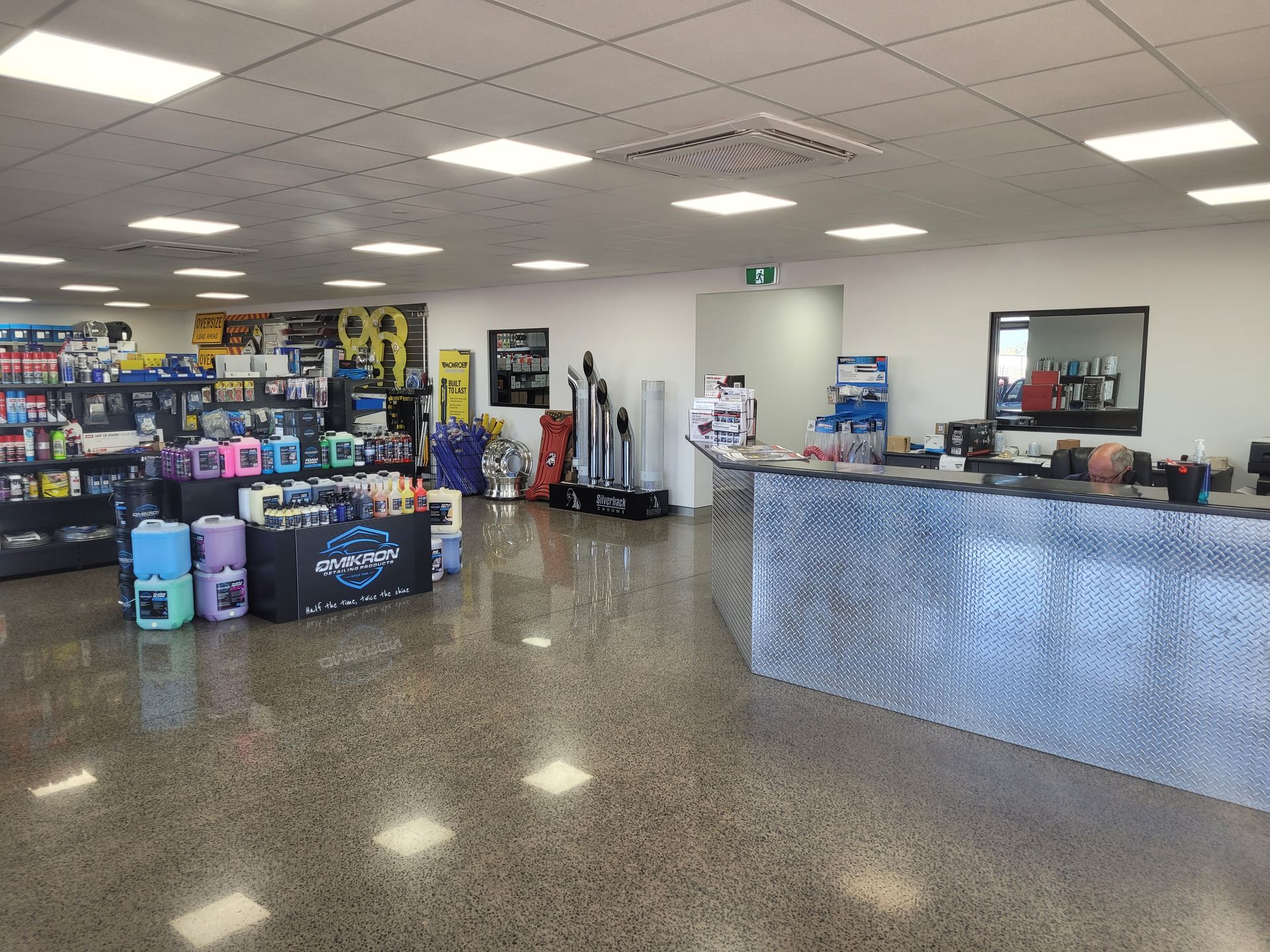 Interior view of a retail store with a polished concrete floor, displaying shelves stocked with products and a diamond-plated front counter — Top End Diesel In Wishart, NT