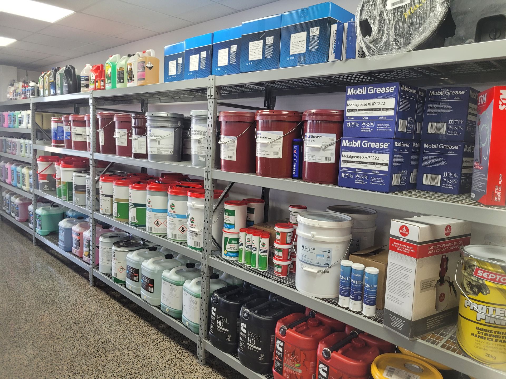 Shelves stocked with various industrial lubricants, oils, and related products in a warehouse — Top End Diesel In Wishart, NT
