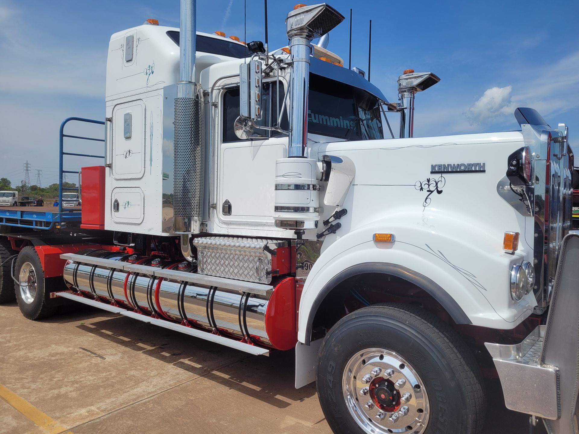 White and red semi-truck with chrome accents, parked outdoors on a sunny day — Top End Diesel In Wishart, NT
