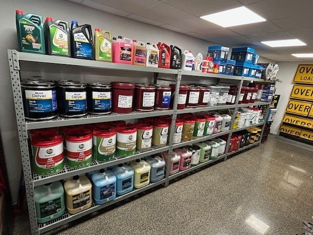 A Person Is Pouring Oil Into a Car Engine — Top End Diesel In Wishart, NT
