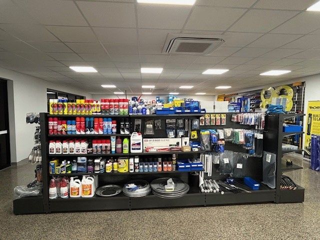 A Bottle of Oil Is Being Poured Into a Car Engine — Top End Diesel In Wishart, NT
