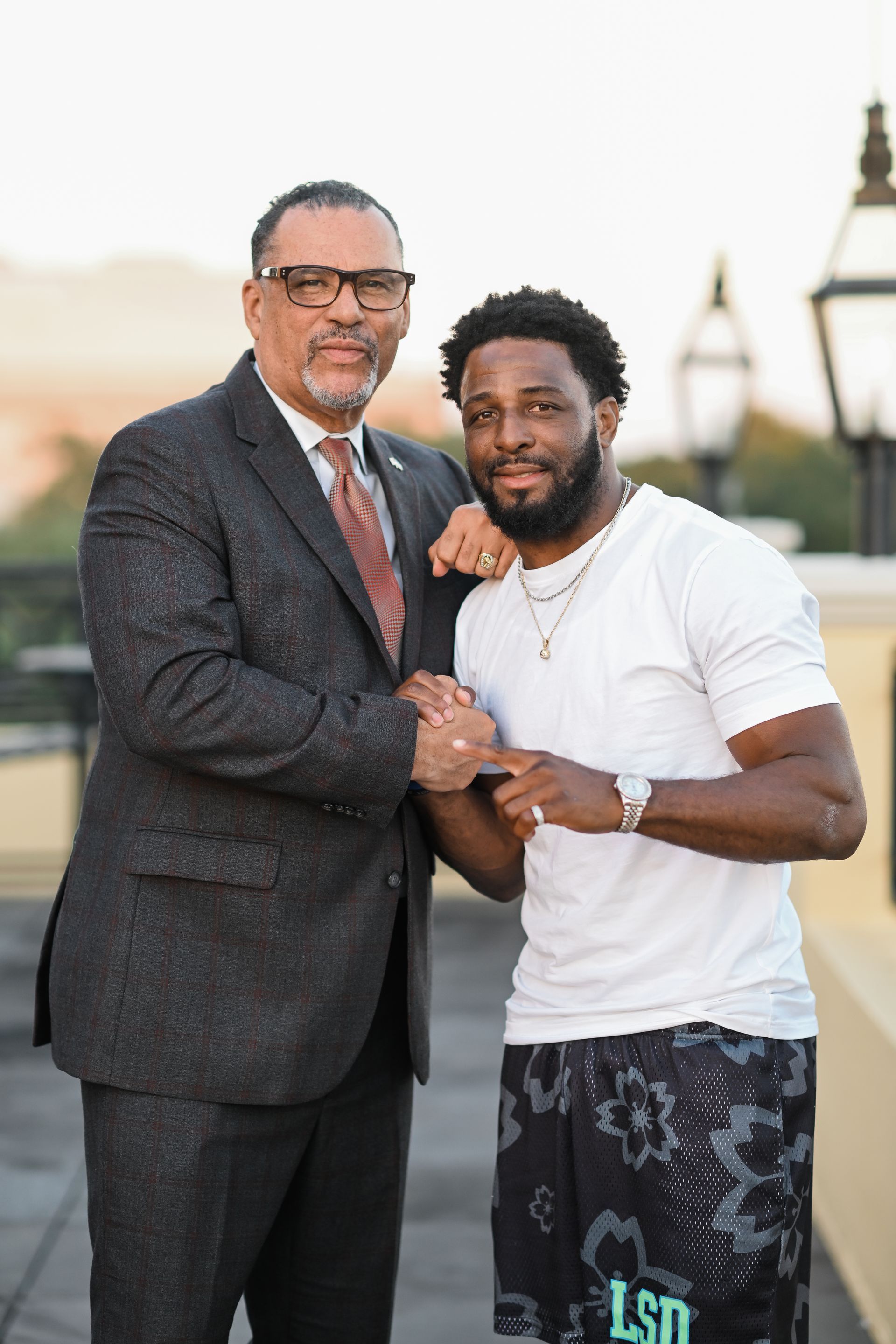 A group of people are sitting on the steps of a building.
