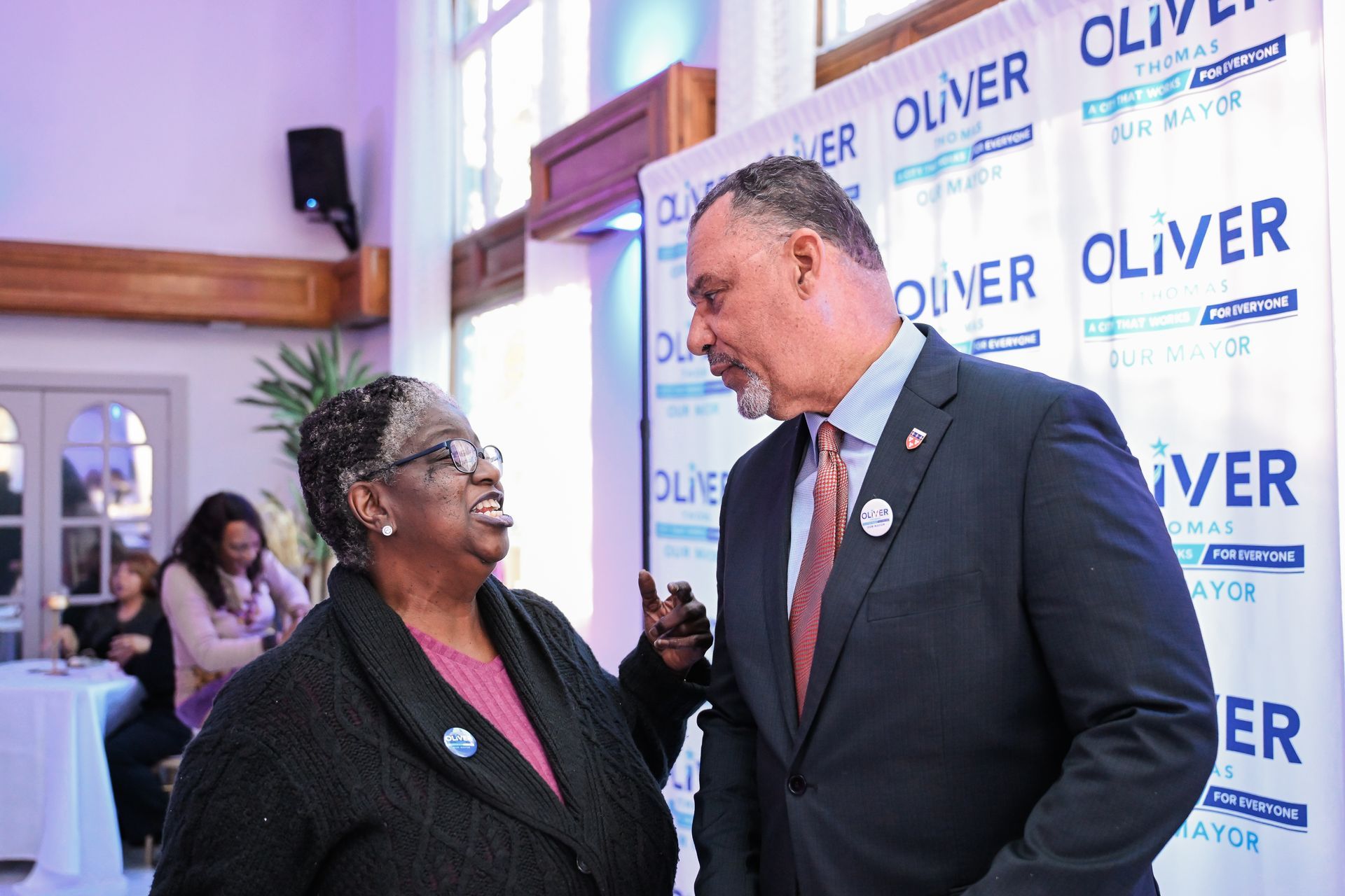 A man and two children are posing for a picture on a basketball court.