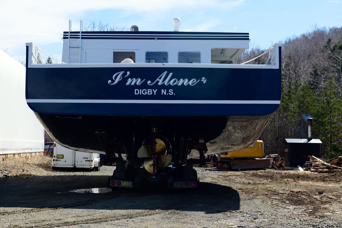 A boat that says i 'm alone on the side of it