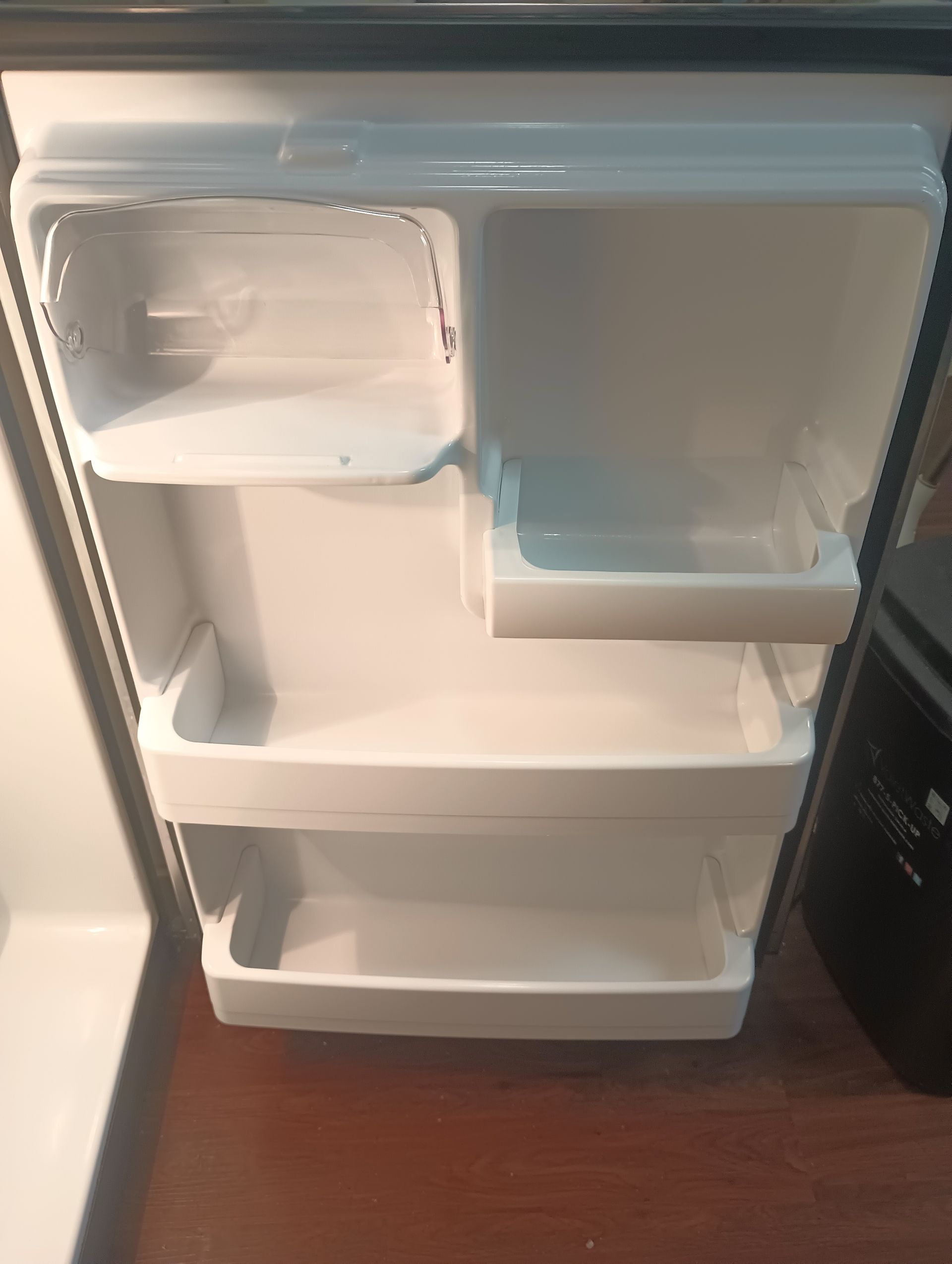 The inside of an empty refrigerator with the door open.