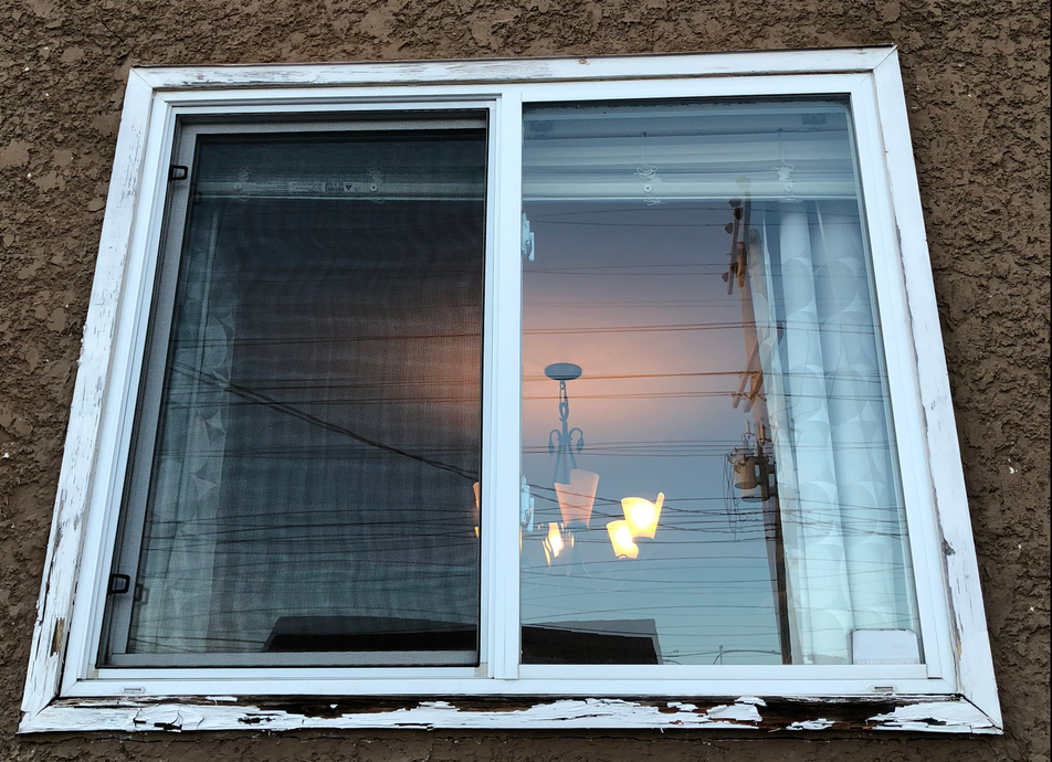 A window with a sliding glass door on a building