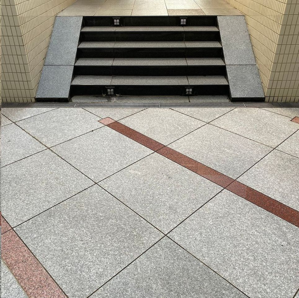 A set of stairs with a ramp in the background