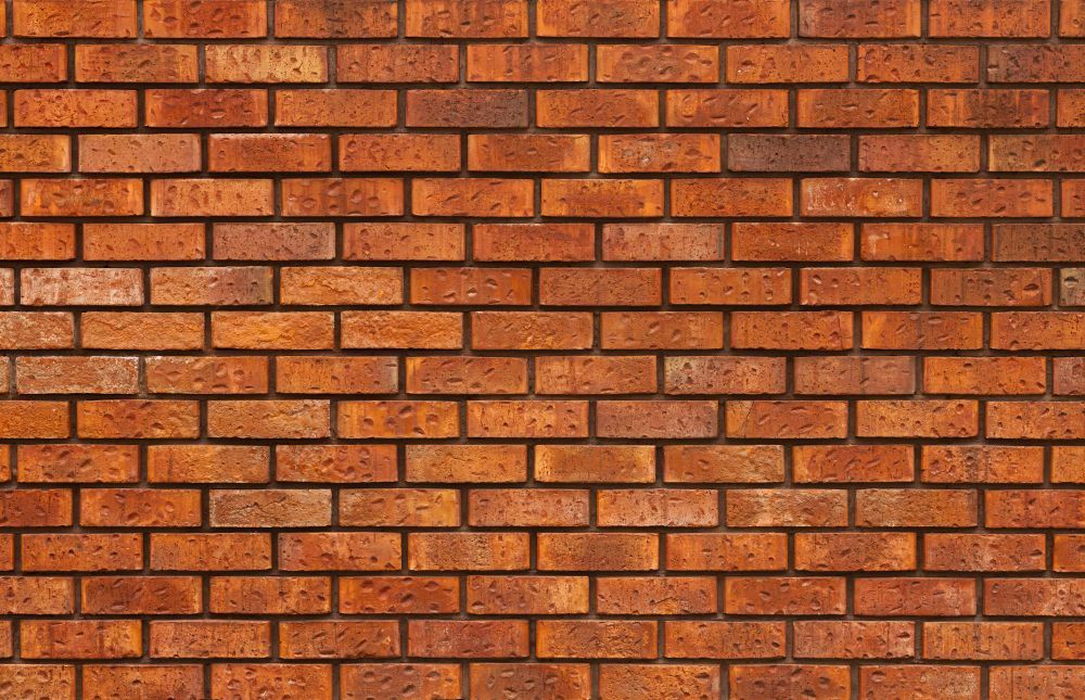 A close up of a red brick wall.