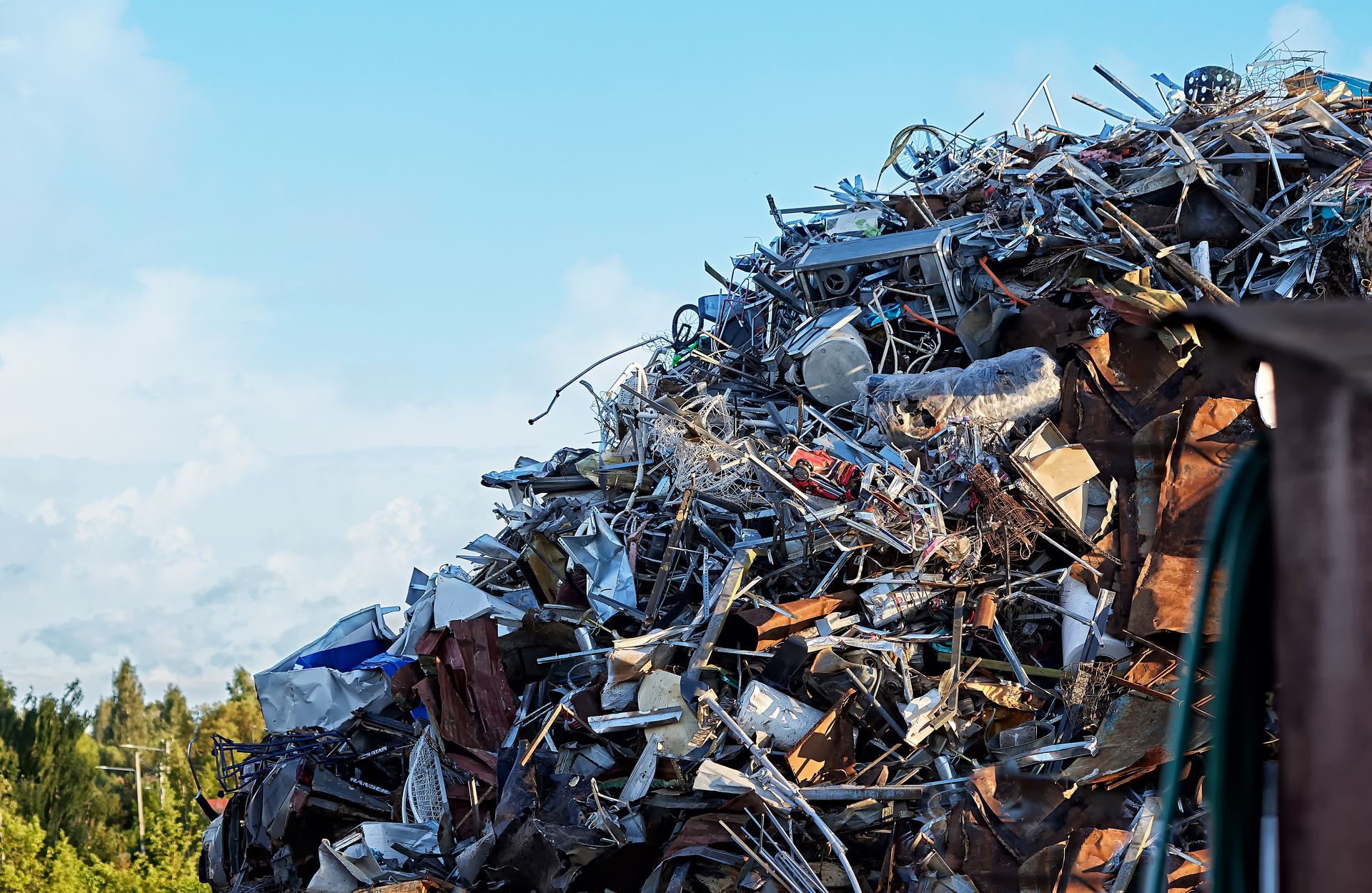 A large pile of scrap metal consisting of various materials outdoors.