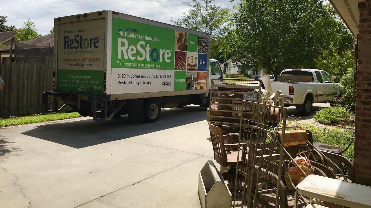 A restore truck is parked in front of a house