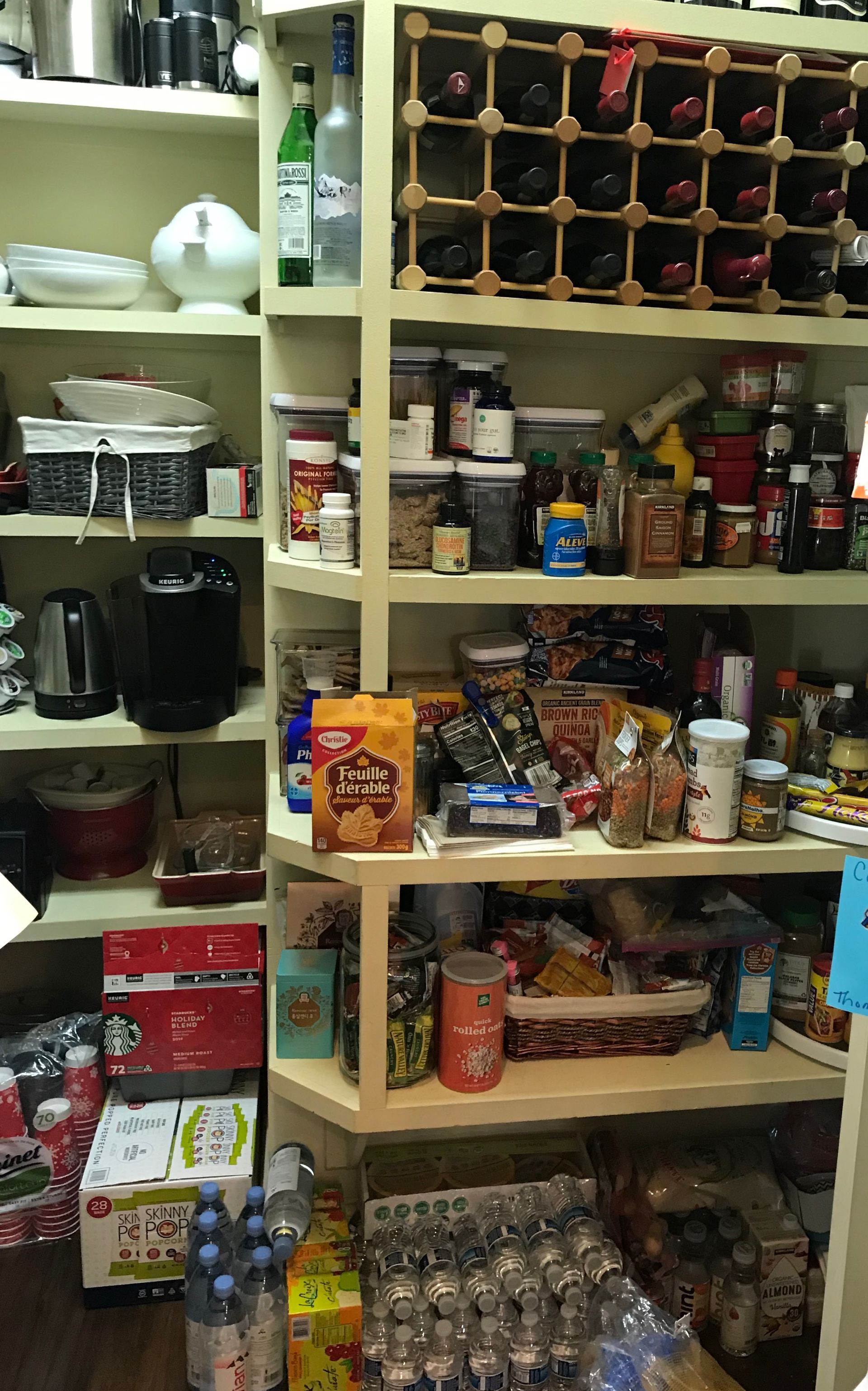 A pantry filled with lots of food and drinks including schweppes