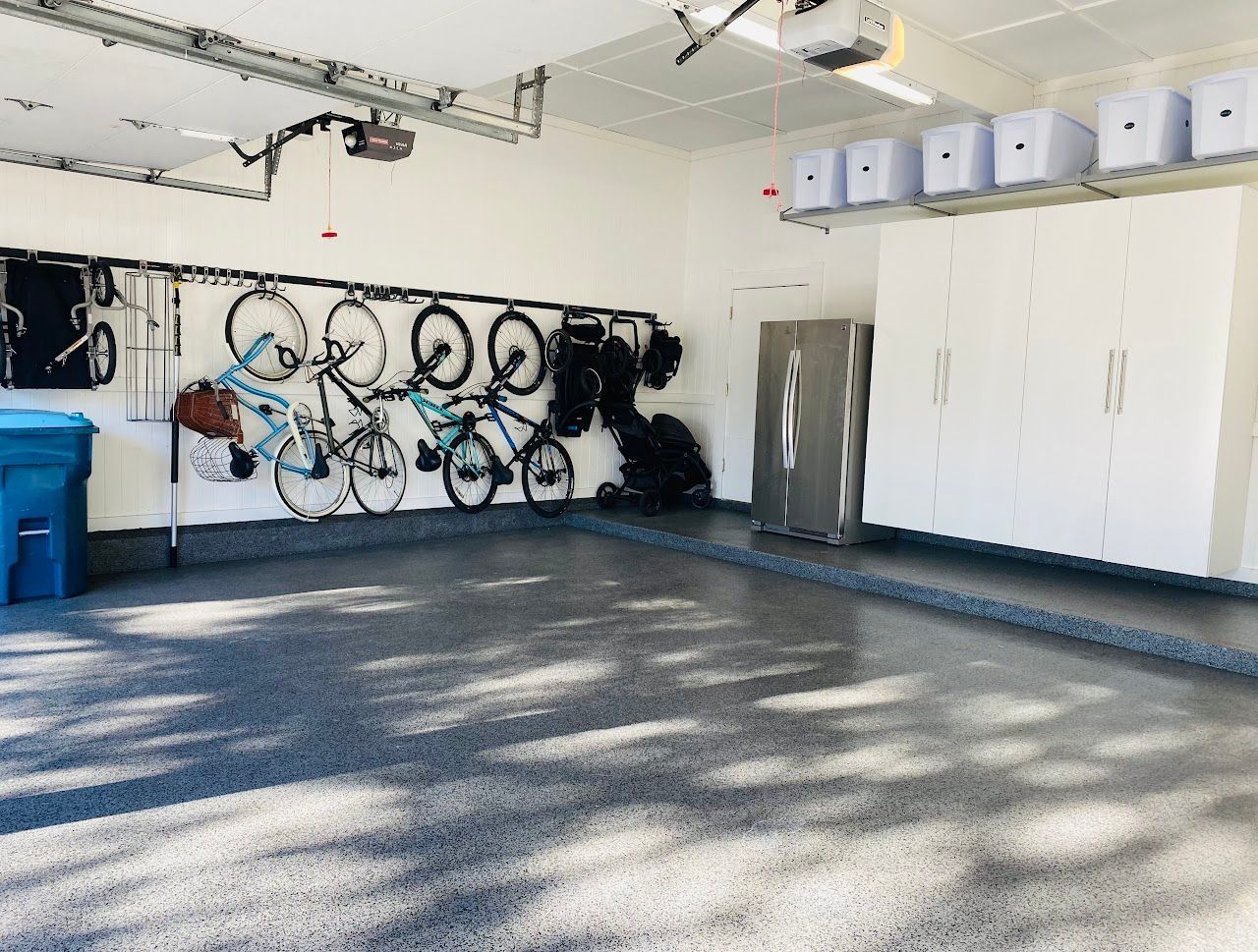 A garage with a lot of bikes hanging on the wall.